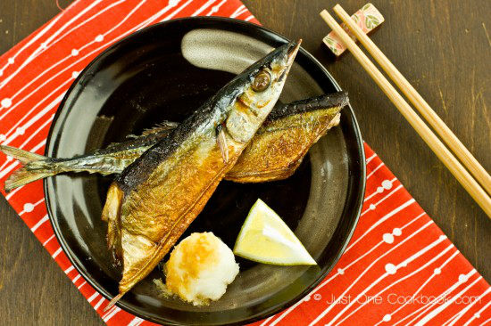 Sanma Shioyaki with daikon radish on a plate.