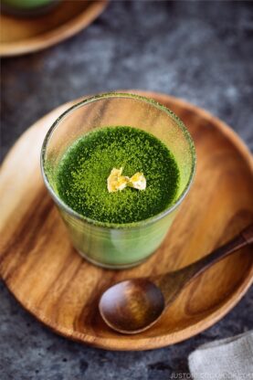 Matcha Vegan Panna Cotta served in a glass bowl, topped with gold flakes!