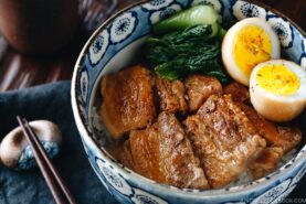 Pressure cooker kakuni (Instant Pot Japanese Pork Belly) served over rice along with eggs and greens in donburi bowl.