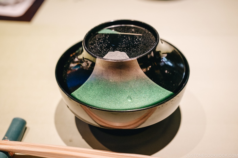 a bowl with decoration of Mount Fuji - Kaiseki Ryori: The Art of the Japanese Refined Multi-course Meal | www.fancyfoodsshow.com