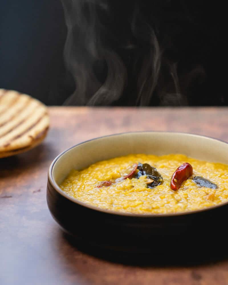 Masoor dal in a bowl, garnished with curry leaves
