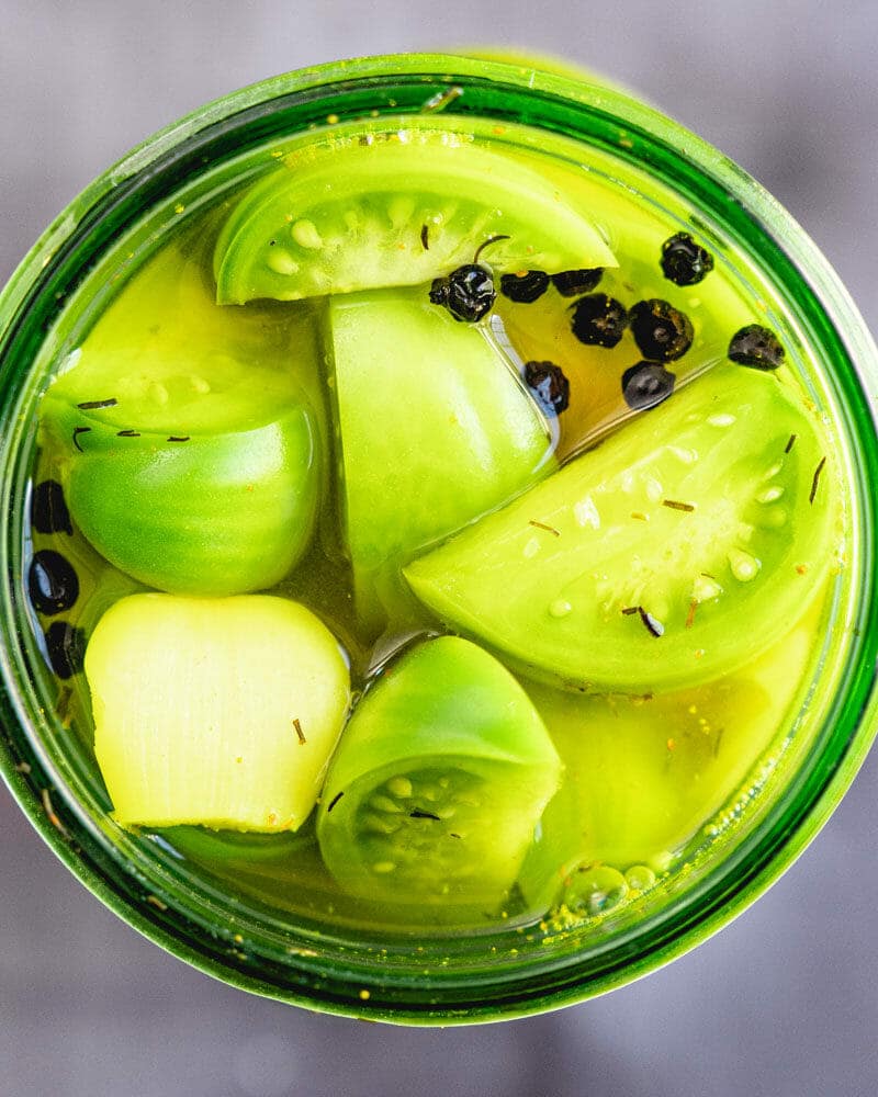 Pickled green tomatoes in a jar