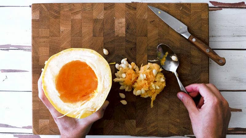 How to cut a spaghetti squash: Scoop out the seeds with a spoon