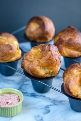 Popovers placed in the special popover pans along with strawberry butter.