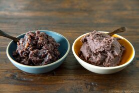 Two bowls containing fine and chunky sweet red bean paste (anko).