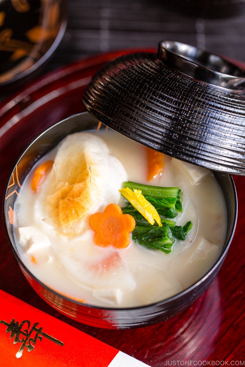 A black and gold lacquered bowl containing Japanese New Year Soup Ozoni.