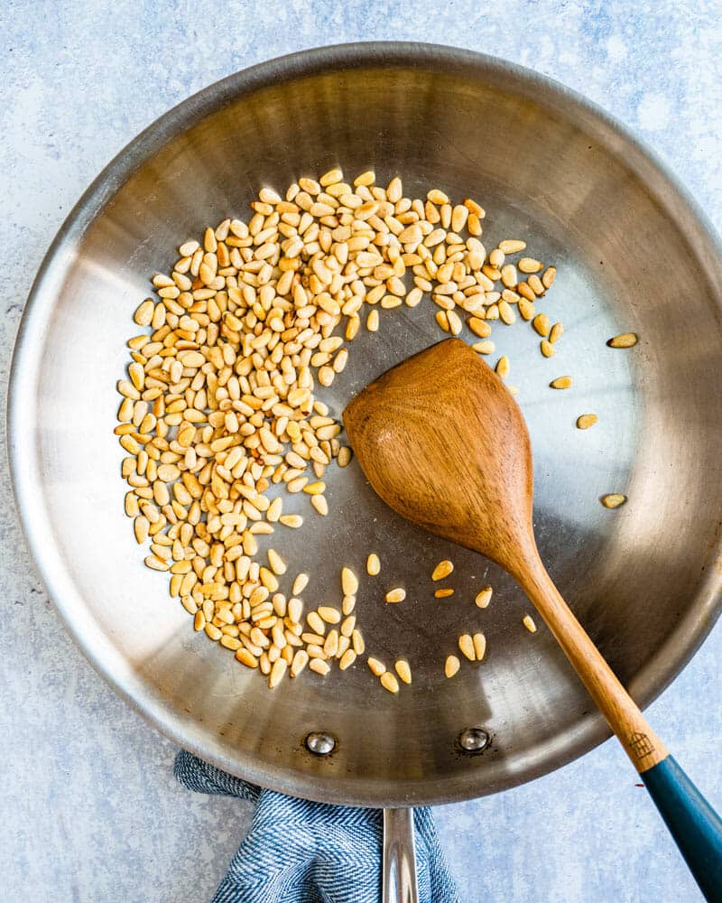 Cauliflower salad step 2: Toast the pine nuts. 