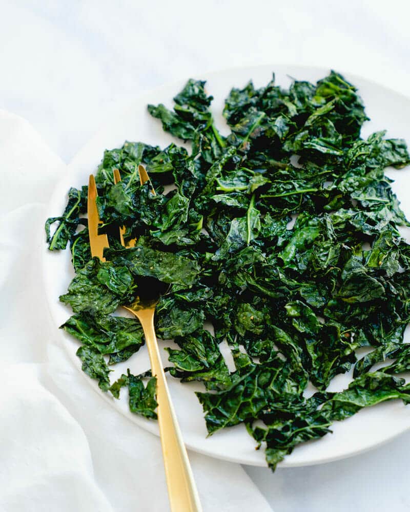 Roasted kale on a platter with serving fork
