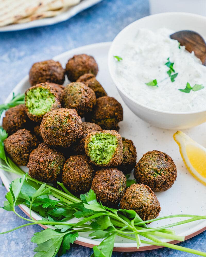 Falafel on plate with cucumber sauce in bowl