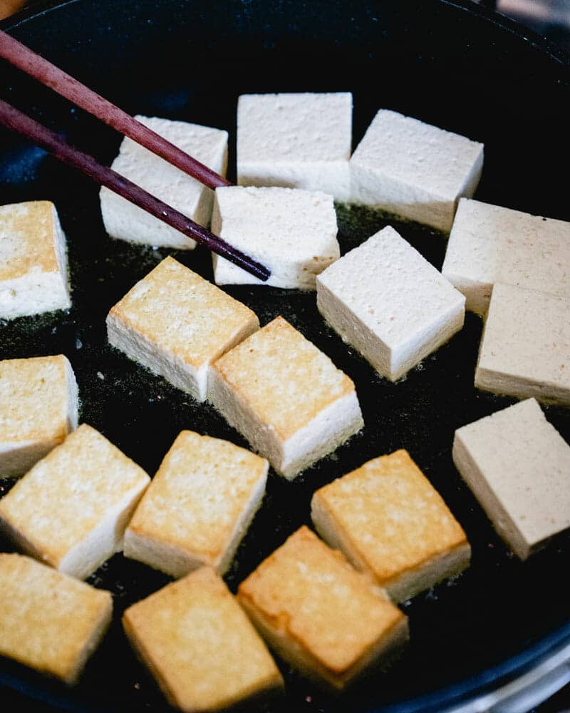 Step 2: Flip the tofu with chopsticks