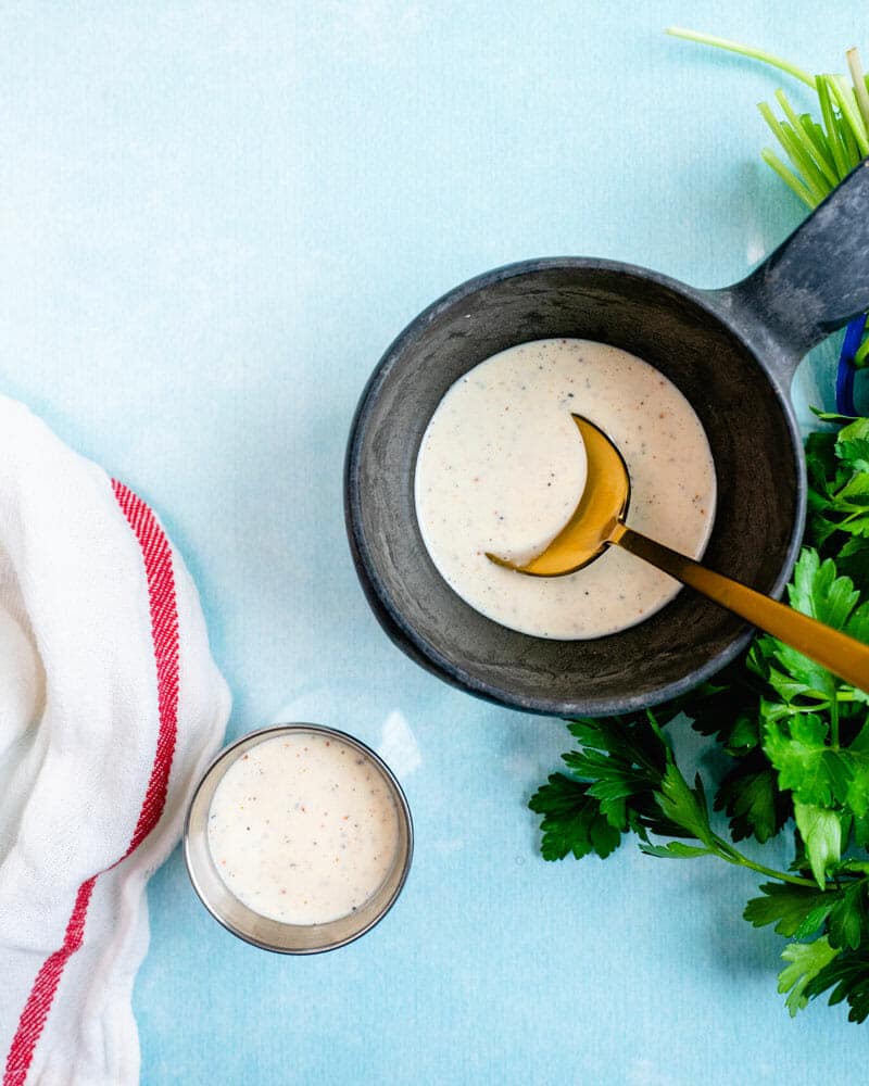 White BBQ sauce in bowl with spoon