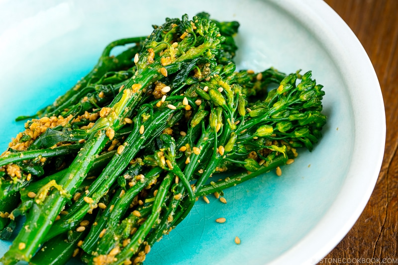 A white bowl containing Broccolini Gomaae.