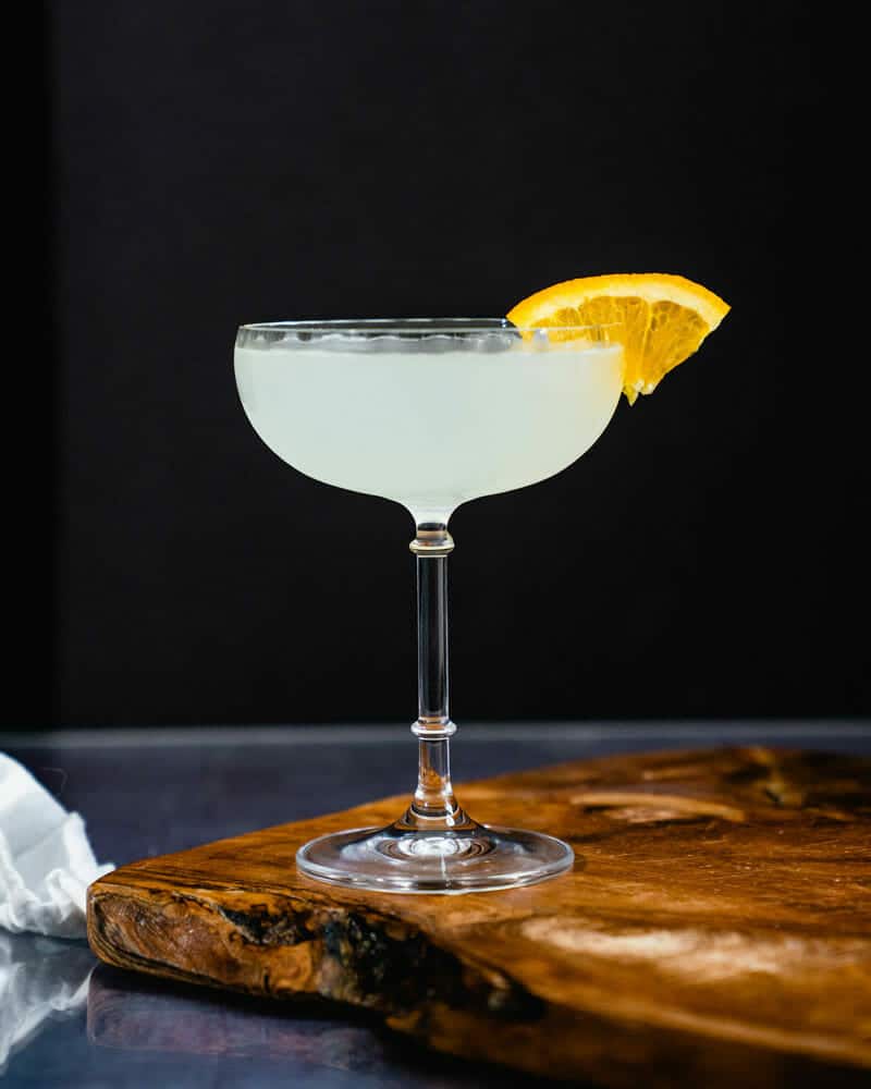 Corpse reviver No 2 cocktail in a tall glass and garnished with a lemon wedge