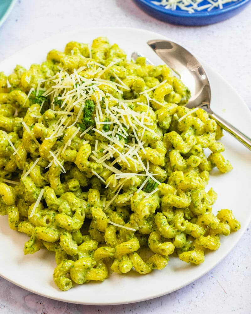 Pesto cavatappi on plate with Parmesan garnish.