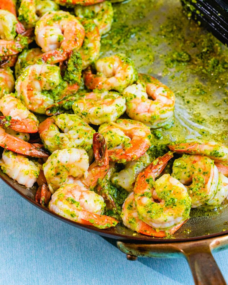 Shrimp in pesto sauce in a skillet