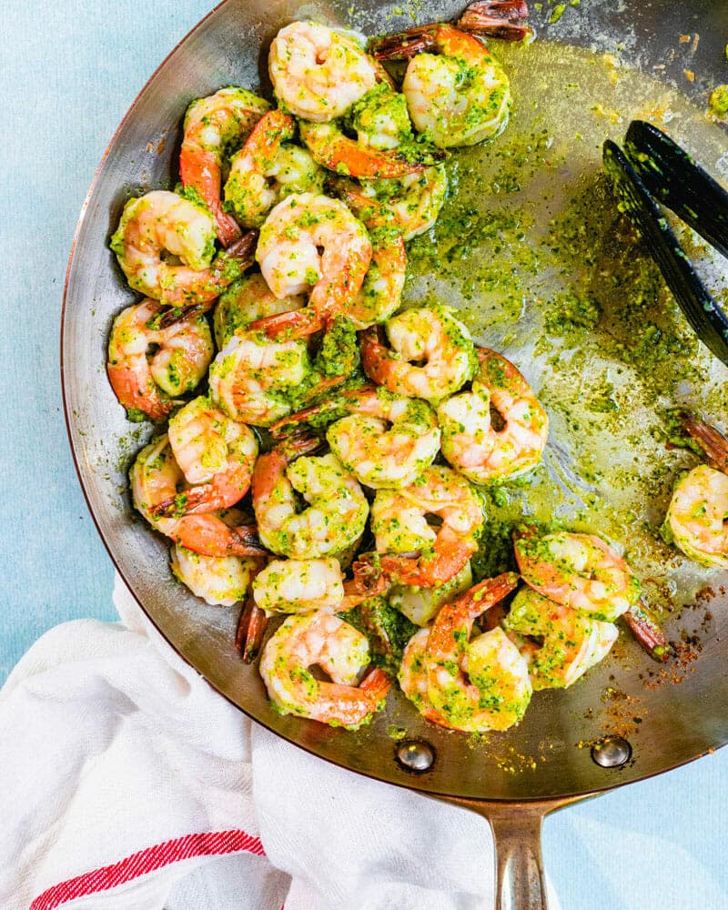Shrimp in pesto sauce in a skillet