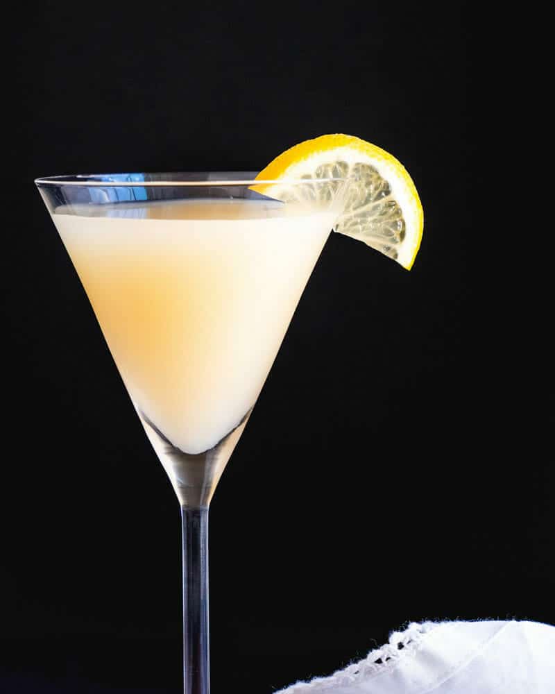 Ginger cocktail in a martini glass, garnished with a lemon