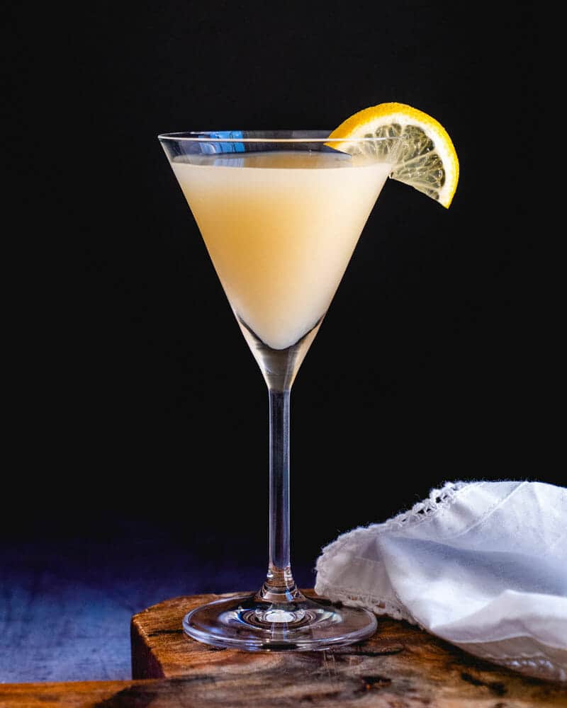 Ginger cocktail in a martini glass, garnished with a lemon