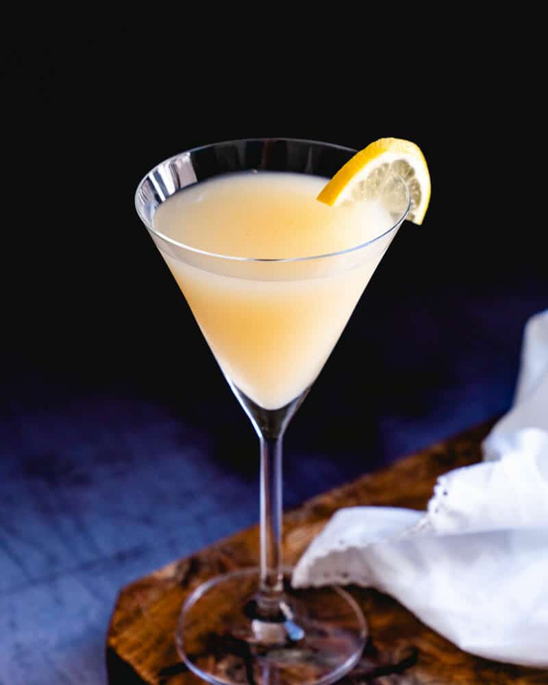 Ginger cocktail in a martini glass, garnished with a lemon