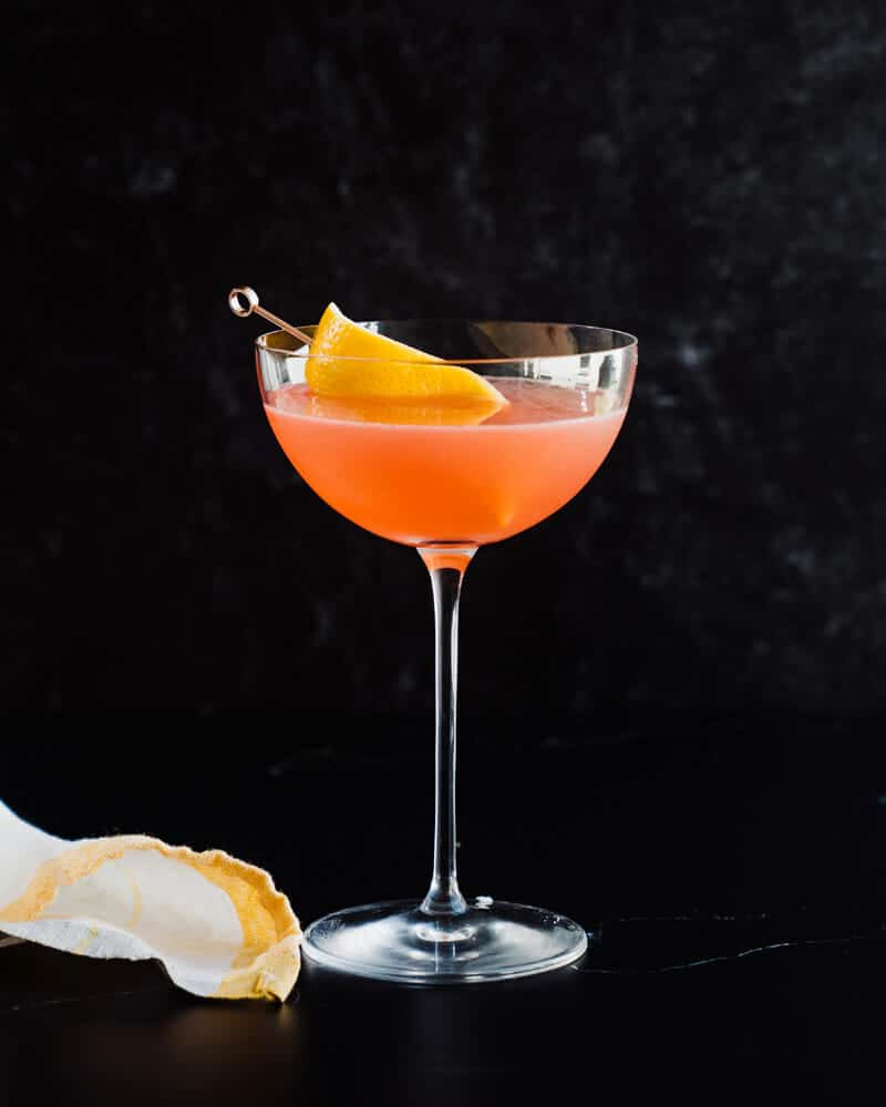 Siesta cocktail in a martini glass, garnished with lemon