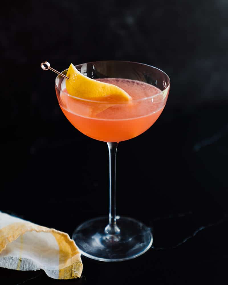 Siesta cocktail in a martini glass, garnished with lemon