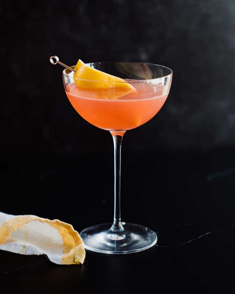 Siesta cocktail in a martini glass, garnished with lemon