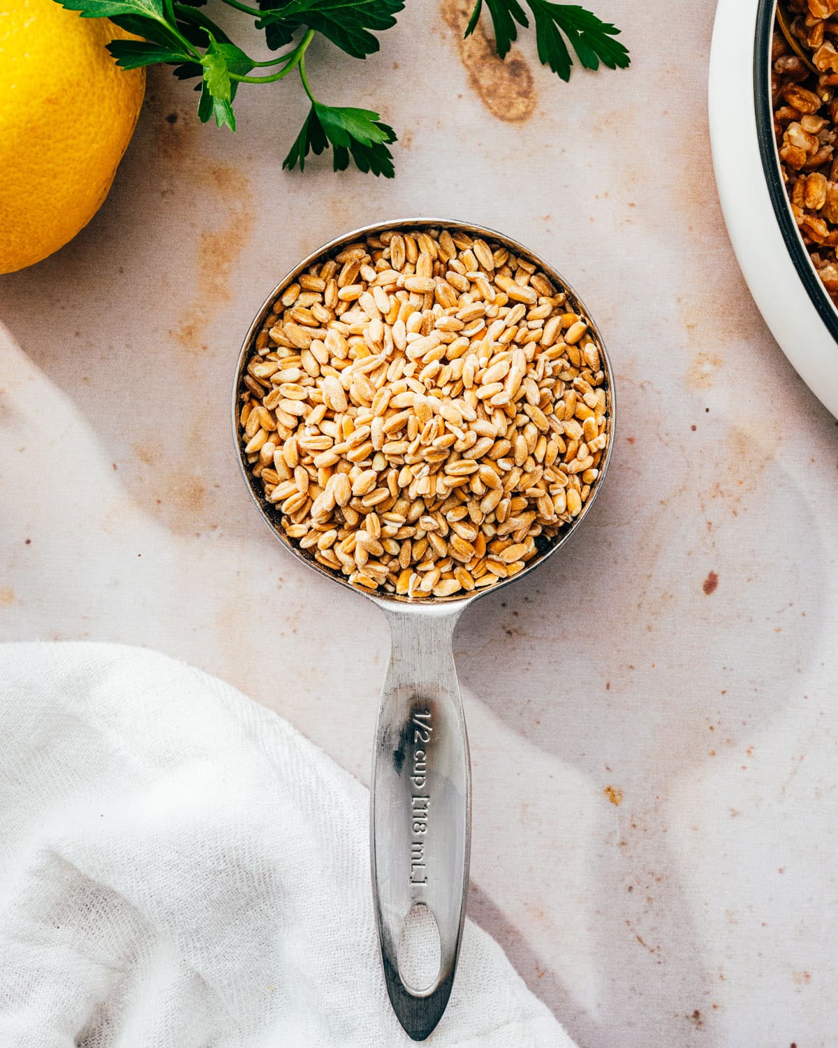 Uncooked farro in measuring cup