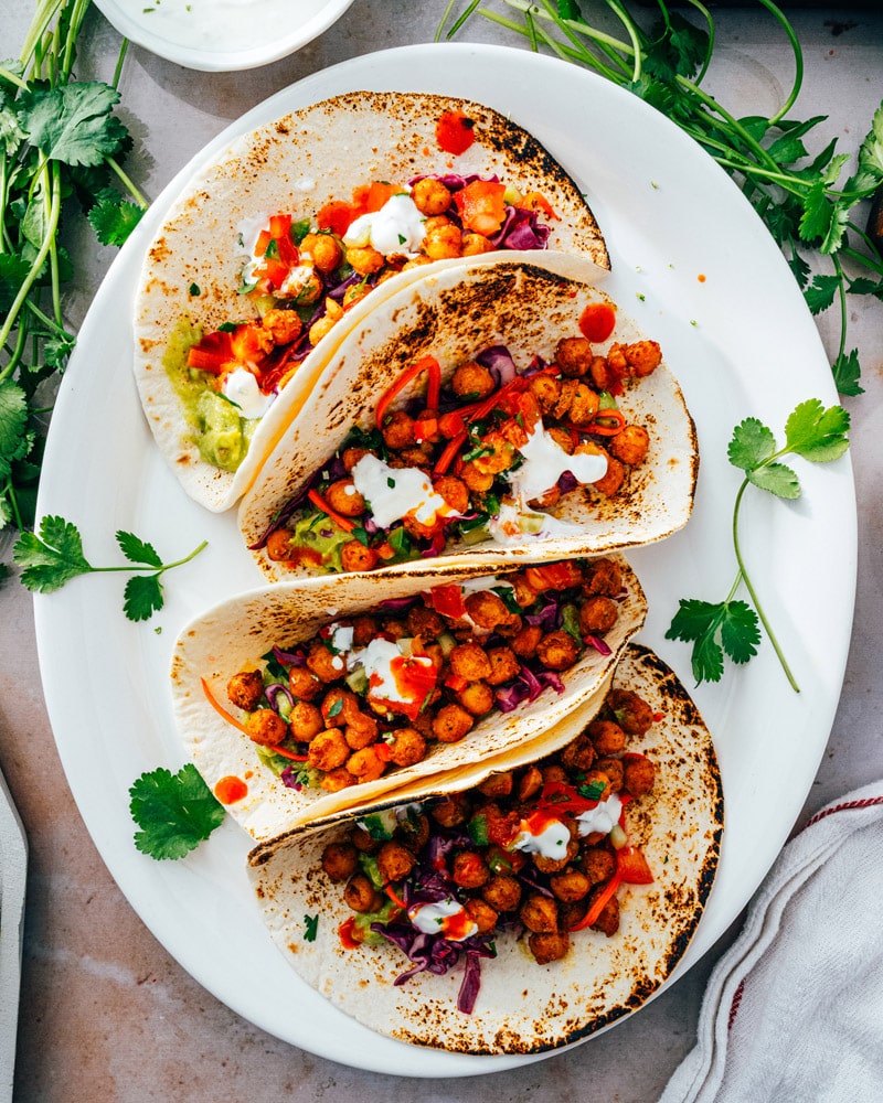 Four chickpea tacos in tortillas with slaw and pico 