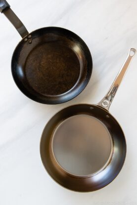 newly seasoned and well used carbon steel fry pan