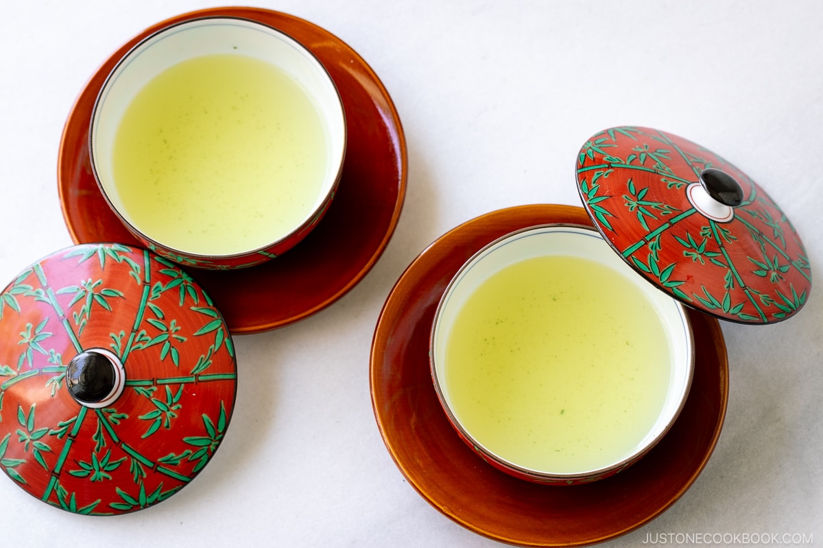 2 red teacup and plates on marble table