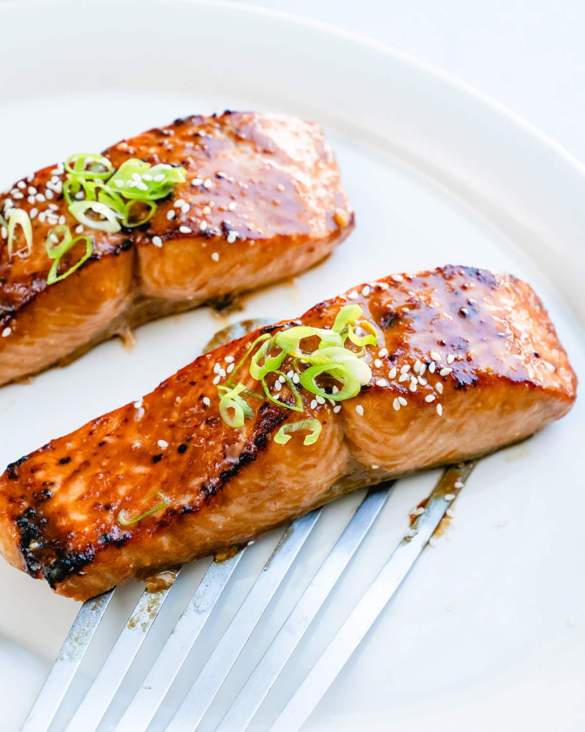 Miso salmon recipe with green onion garnish.