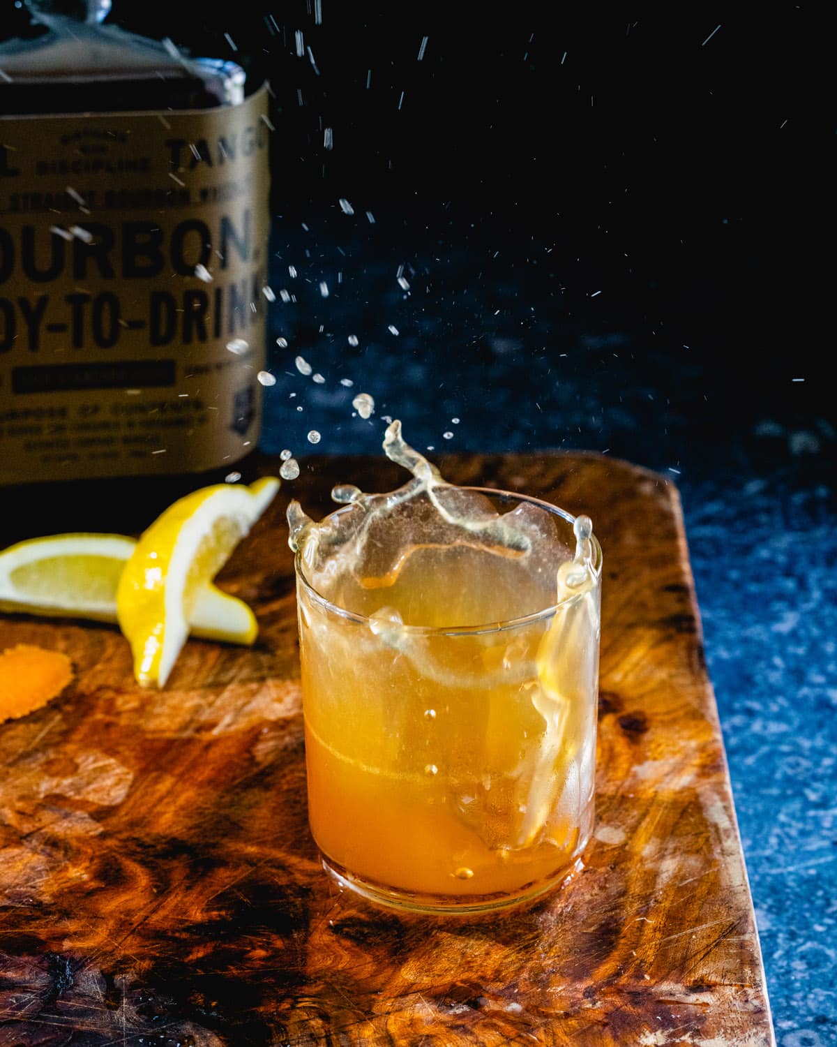 Easy whiskey sour recipe splashing out of glass