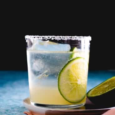 virgin margarita with lime garnishes and salt rim.