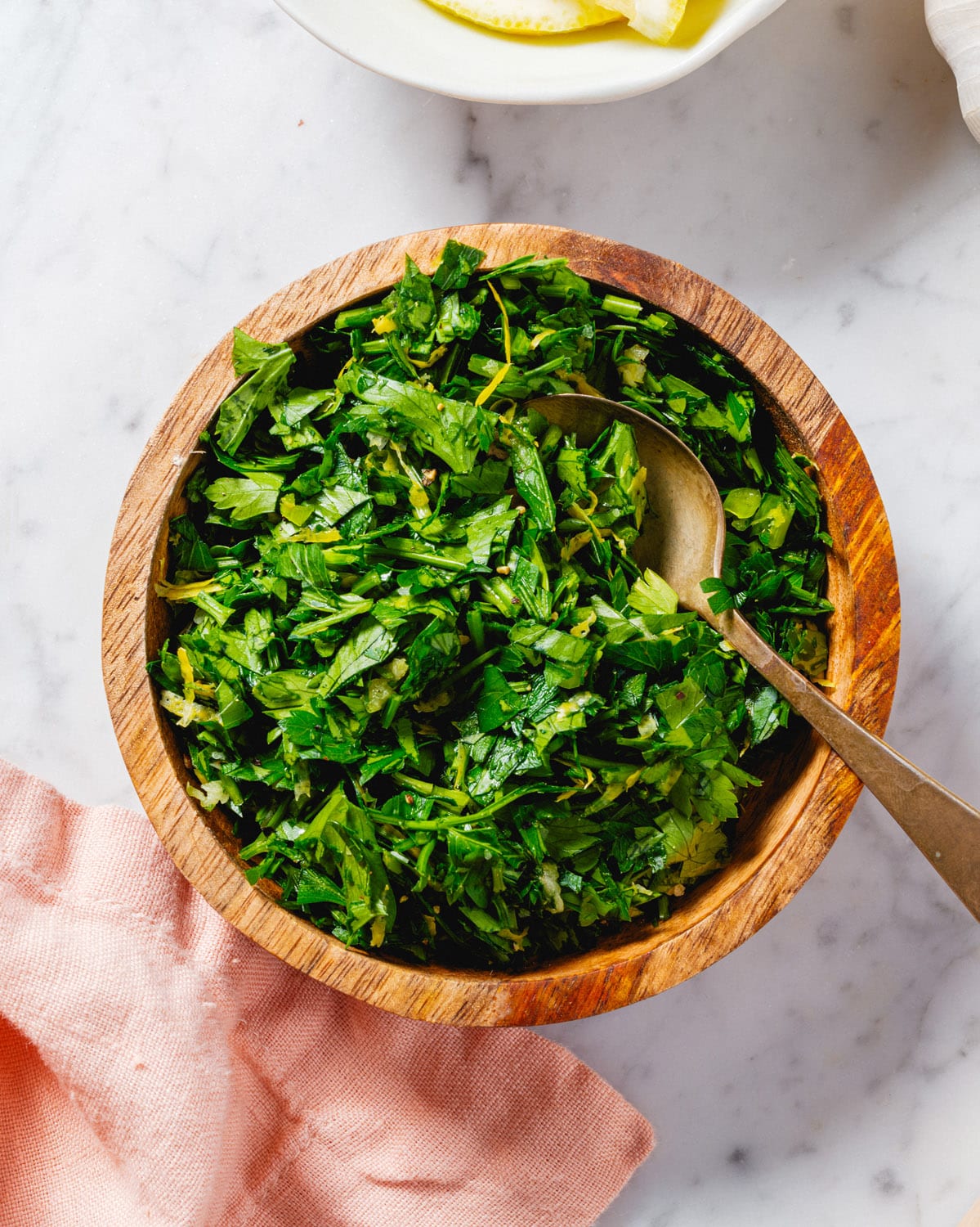 Gremolata in bowl with parsley, lemon zest and garlic