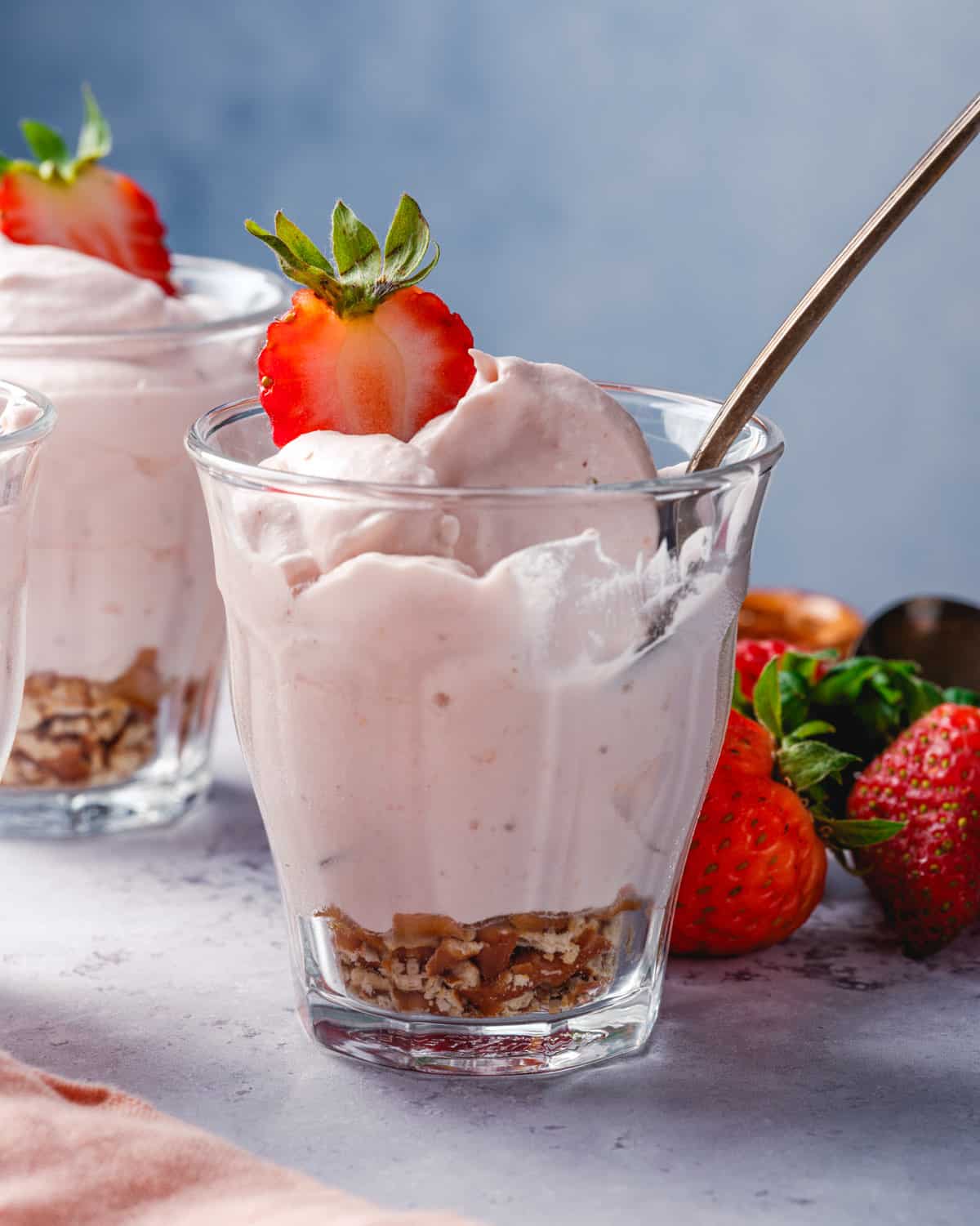 Strawberry Mousse recipe in cup with crushed pretzels.