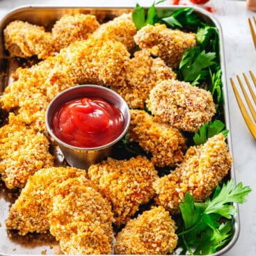 Chicken Nuggets on a tray with ketchup.