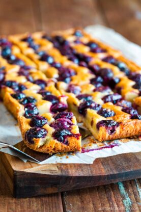 Cherry bards on top of a wooden cutting board.