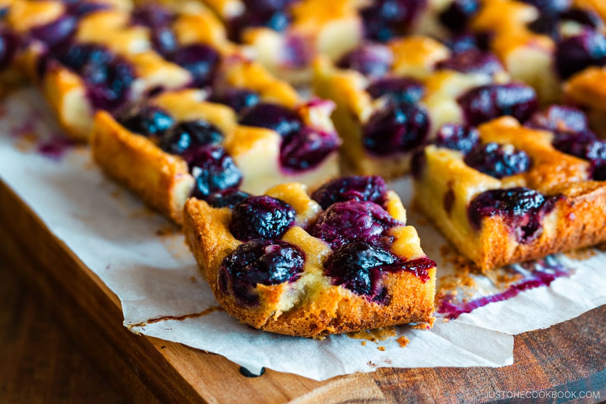 Cherry bards on top of a wooden cutting board.