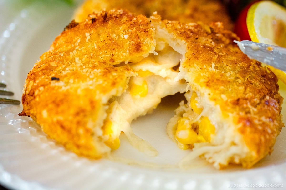 A white plate containing creamy crab croquettes.