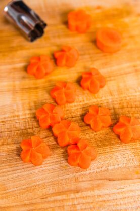 Carrot coins carved into Japanese ume plum shapes.