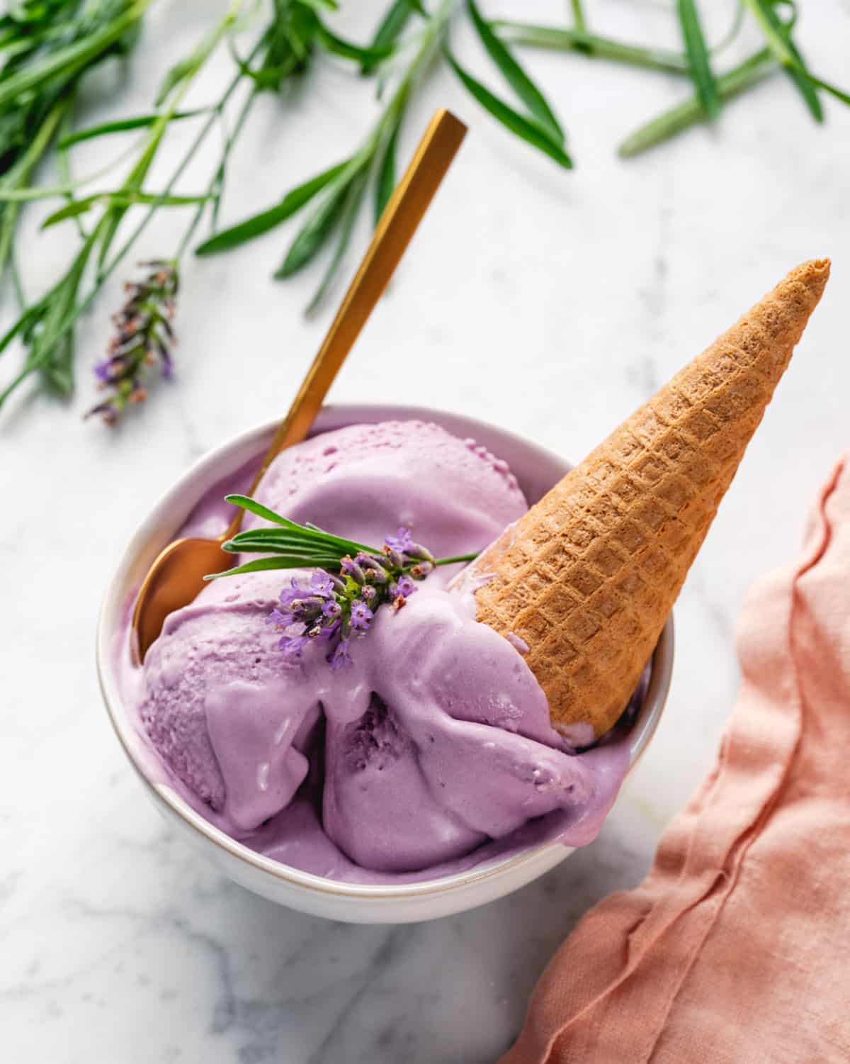 Lavender Ice Cream in cone in bowl.