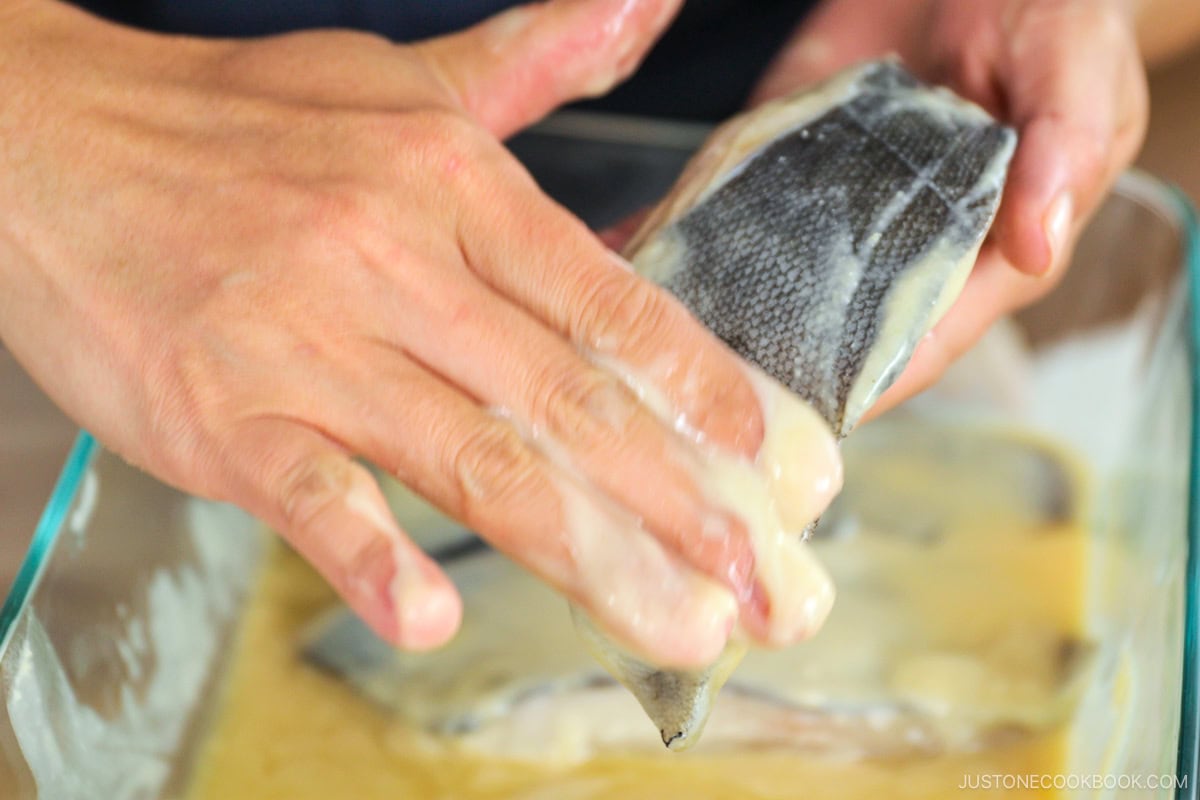 Removing miso from the fish.