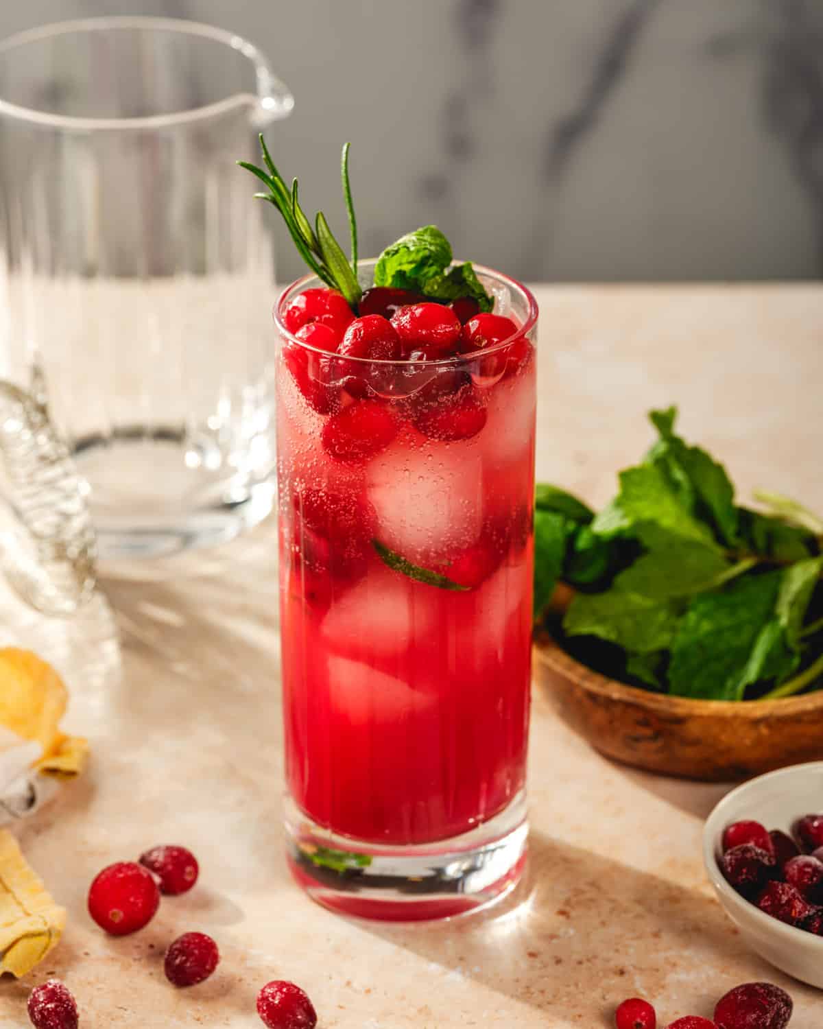 Ginger beer mocktail in collins glass with cranberries