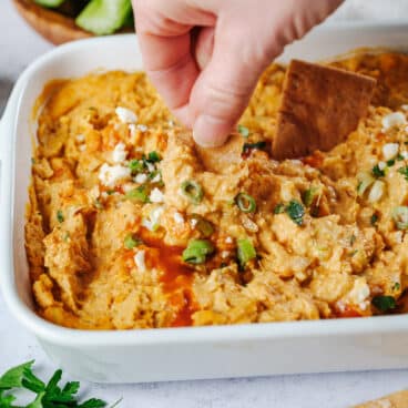 Hand dipping healthy buffalo chicken dip