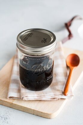 A glass mason jar containing homemade teriyaki sauce.