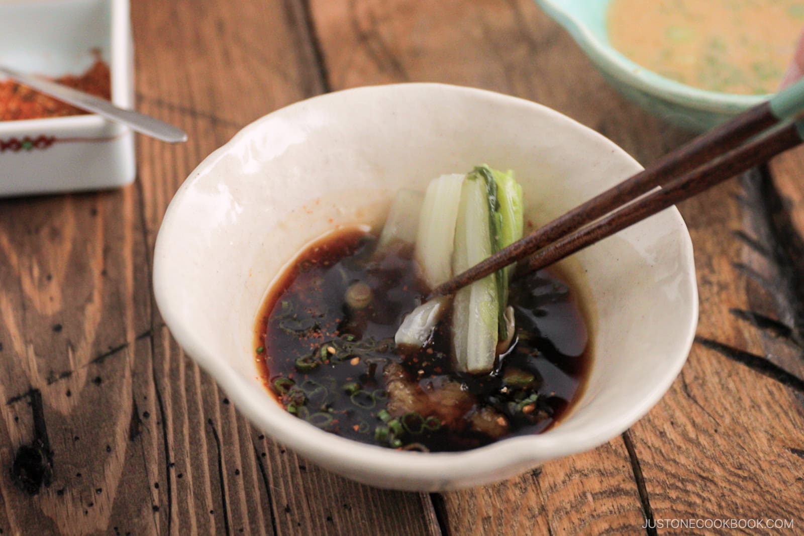 Dipping the cooked vegetables in the ponzu sauce.