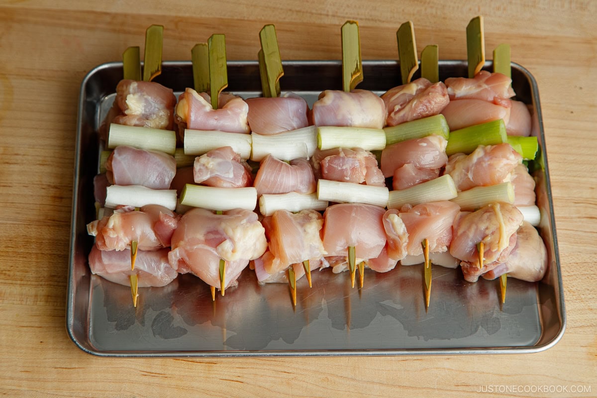 Chicken and scallion skewers prepared.